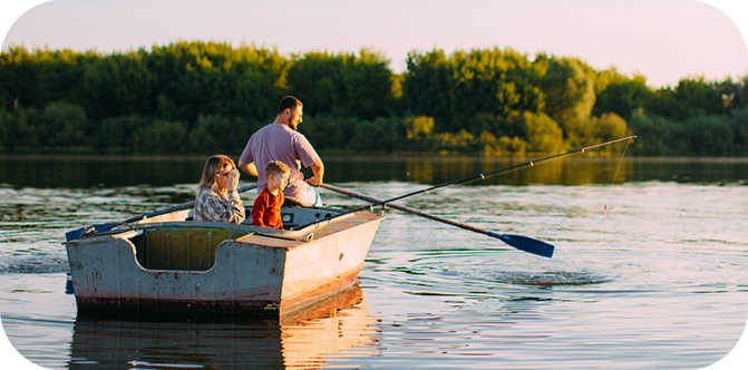 A father in a row boat with his two kids